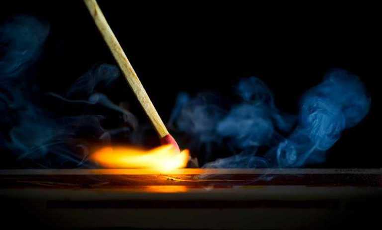 A match striking a surface to flame that could prove dangerous to consumer fabric not tested to ASTM D1230-22.