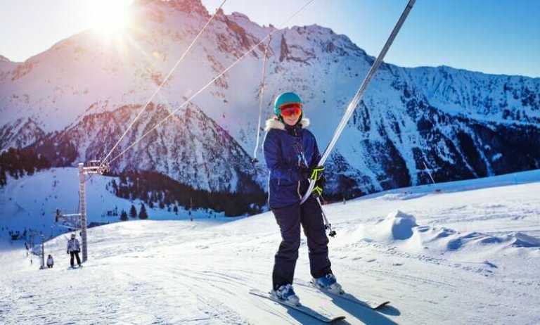Woman getting up the slope on a t-bar kept safe with ANSI B77.1-2022 requirements.