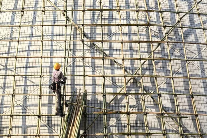 Construction worker in Hong Kong on bamboo scaffolding.