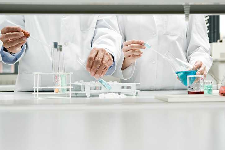 Scientists using bioprocessing technology and equipment in a lab adhering to ASME BPE-2022.