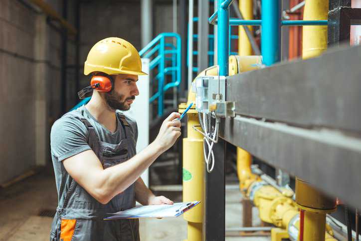 Electrician using an extended version (EXV) IEC standard to check an electric power system.