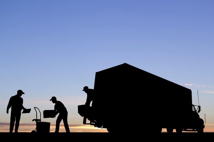 Workers bending over because they do have access to an industrial tilter that adheres to ANSI MH29.2-2020.