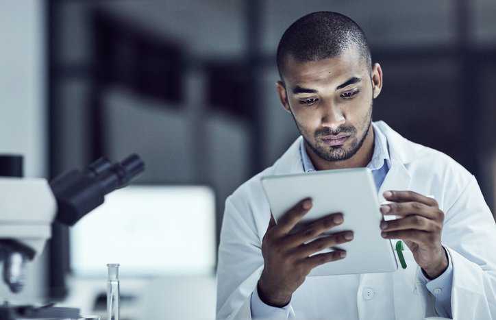 Lab technician reviewing validity of results as part of beneficial laboratory practice.