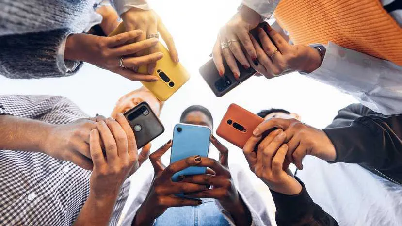 Teens using smartphones in WLANs, adhering to IEEE 802.11-2020.
