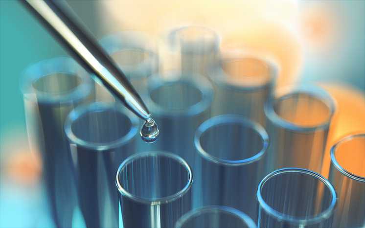 Liquid dropping from pipette into test tube lineup.