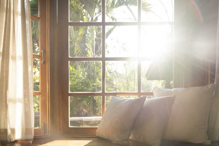 Living room with windows and natural light adhering to ASTM water test method in ASTM E1105-15(2023).