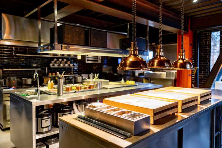 Beautiful commercial kitchen with colorful copper NSF/ANSI 51-2023 food equipment materials to prepare the menu.