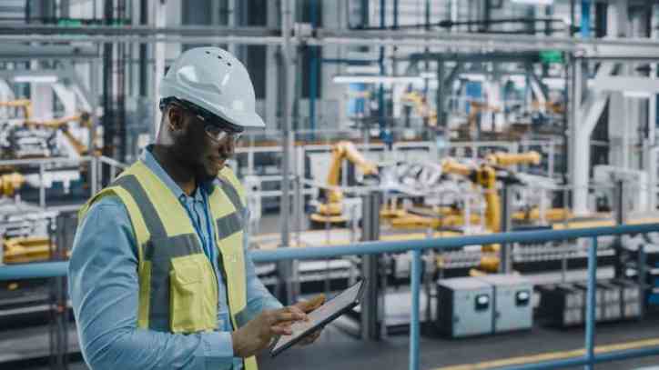Operator making sure large machines adhere to safety requirements in ANSI B11.25-2022.