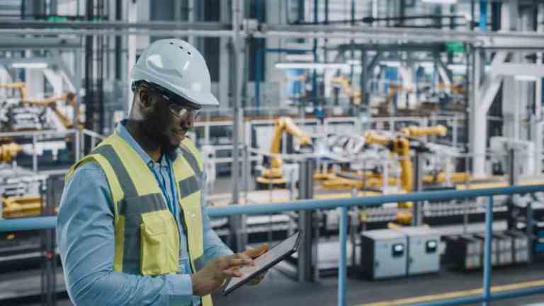 Operator making sure large machines adhere to safety requirements in ANSI B11.25-2022.