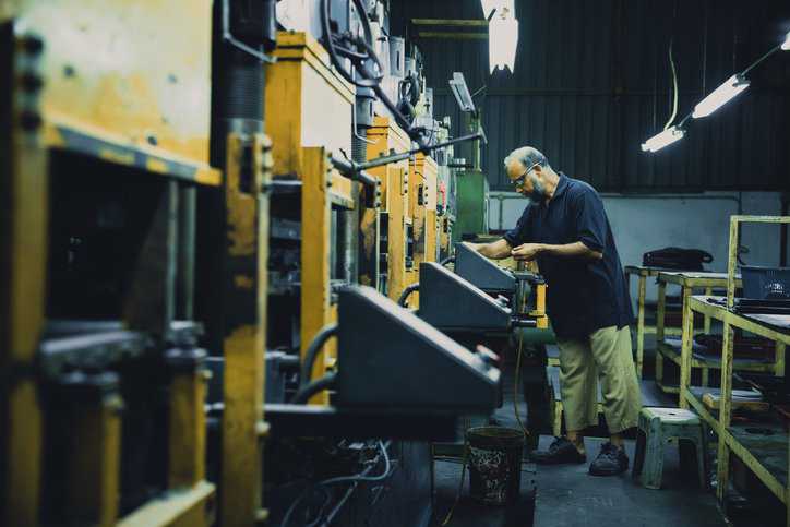 Manufacturer worker putting vulcanized rubber and thermoplastic into an over to adhere to heat aging testing specified in ISO 188:2023.
