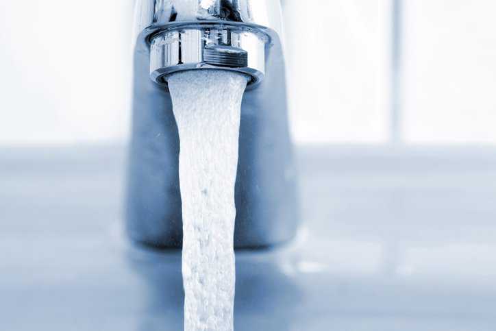 Water leaking from faucet nice and clean with NSF/ANSI 55-2024 UV microbiological treatment.