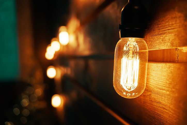 Electric incandescent light bulb adhering to ANSI C78.20-2022.