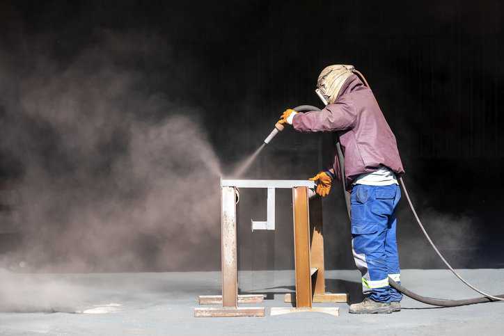 Sand blasting, also known as abrasive blasting, adhering to ANSI/ASSP Z9.4-2011 (R2021).