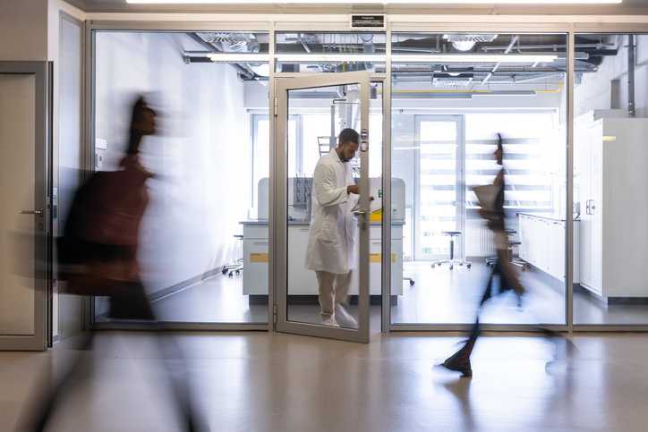 Scientist exiting an environmental lab that has been accredited to DoD ELAP.