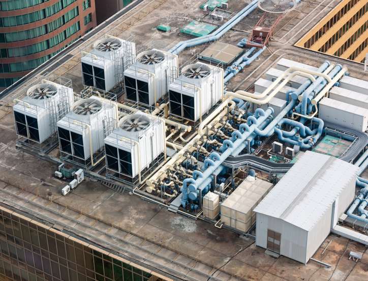 White mechanical building systems with spinning fans safely following the 2021 International Mechanical Code (IMC).