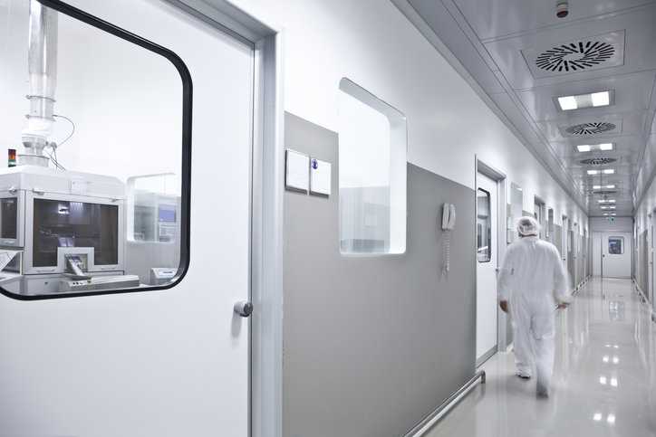Lab professional walking to cleanroom to sort out a flexible scope of accreditation.