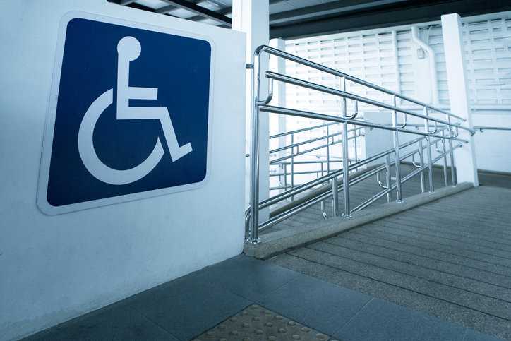 Wheelchair ramp leading up to garage that follows both ANSI A117.1 and ADA guidelines for accessible design.