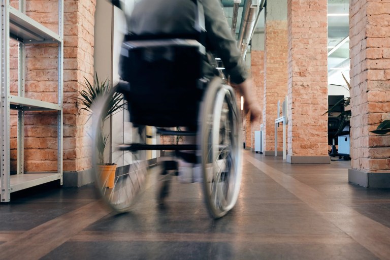 Accessible building adhering to ISO 21542:2021, so person in a wheelchair can move around.