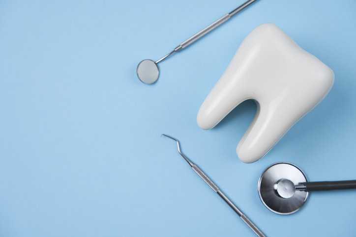 Dental equipment on blue background.