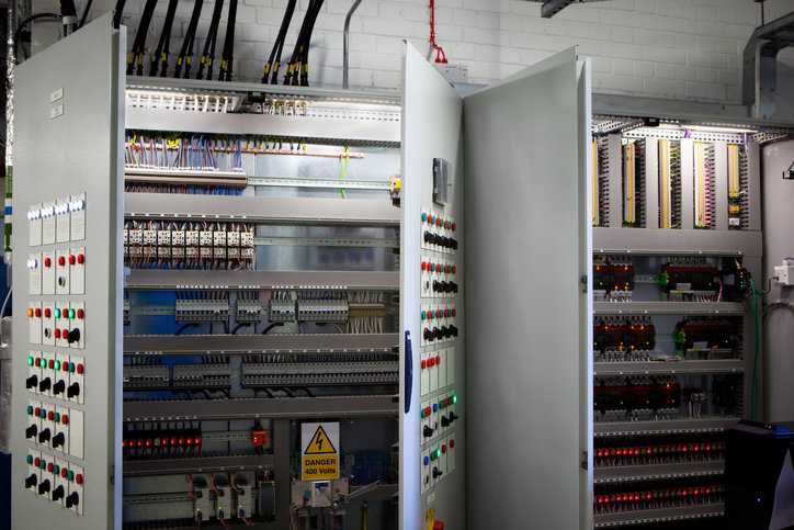 Electrical power equipment cabinet open and following ANSI/NETA MTS-2023 Maintenance Testing Specifications