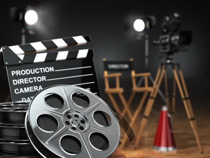 Cinema concept of vintage film reels, clapperboard and projector