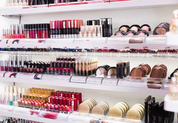 Variety of cosmetics products in a makeup store adhering to ISO 16128-1:2016 specifications for organic ingredients.