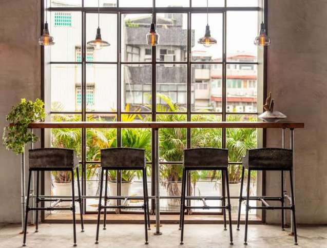 Sustainable green co-working office space with office chairs adhering to ISO 7173:2023.