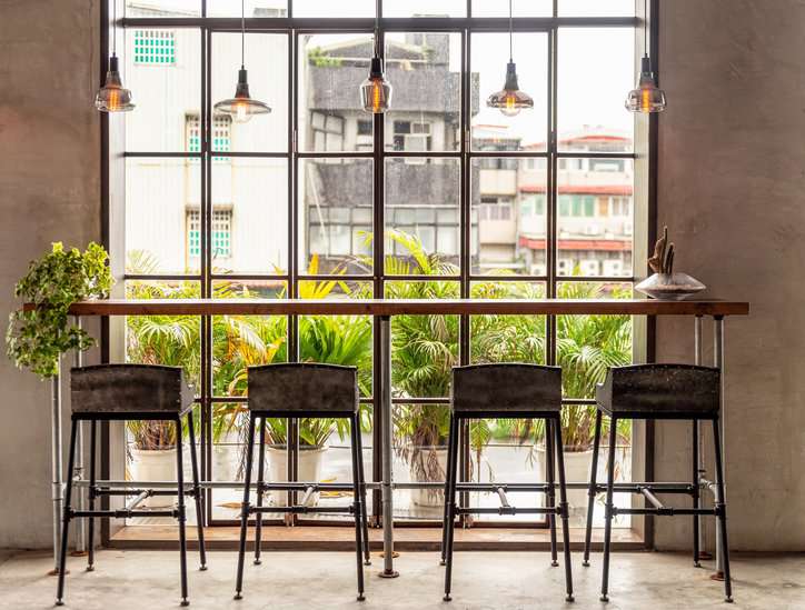 Sustainable green co-working office space with office chairs adhering to ISO 7173:2023.