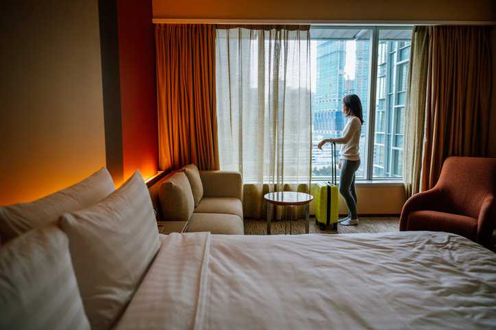 Tourist at hotel breathing in healthy ISO 50001 air while on vacation.