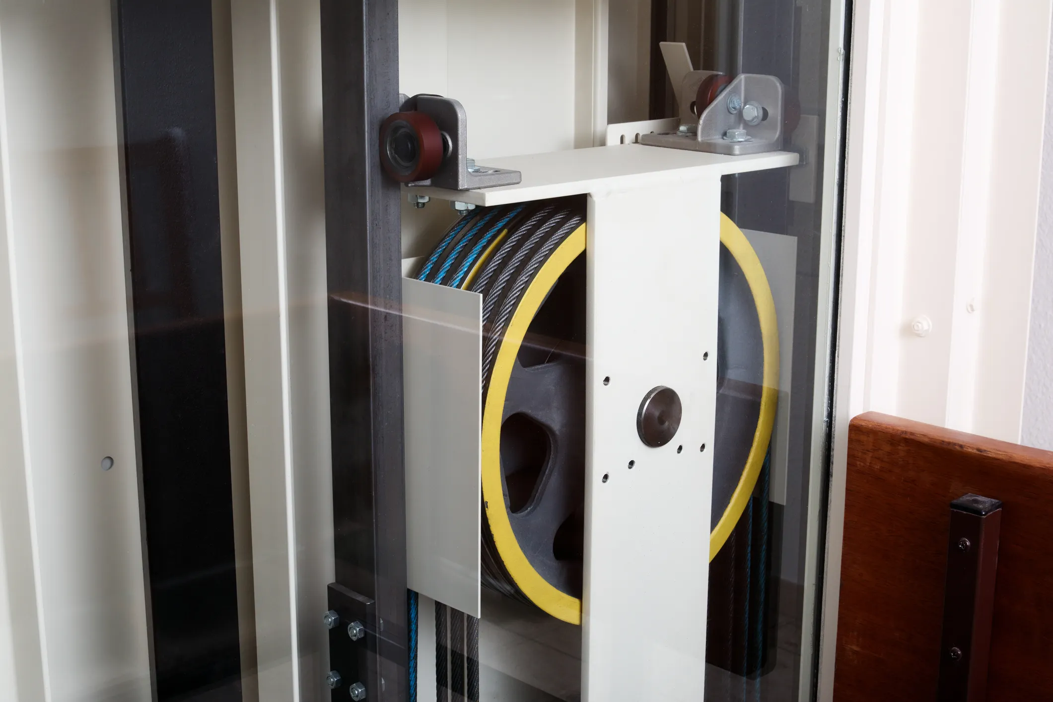 Yellow elevator cable pulley that follows ASME A17.1