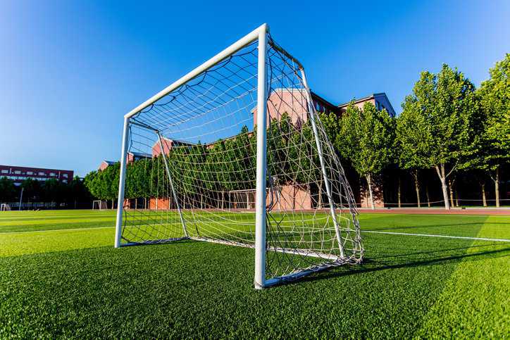 Soccer goal on a grass filed adhering to ASTM F2950-14(2021).
