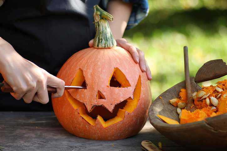 Pumpkin carved on Halloween with a monster face with cutlery that adheres to ISO 8442-2:1997.