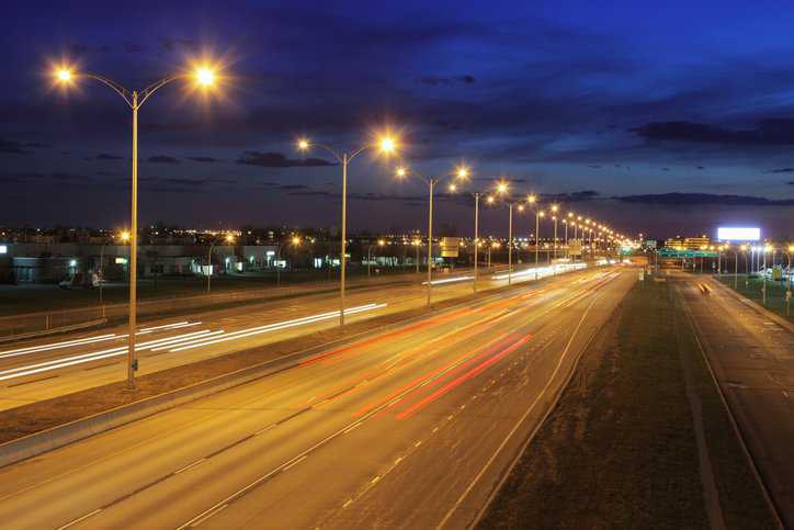 Roadway lighting on a dark night with bright street lights adhering to ANSI C136.11-2011 (S2021).
