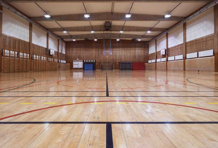 Interior of a gym with a sport and dance surface adhering to ASTM F3248-17.