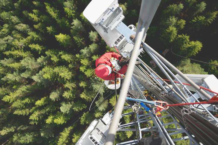 Telecommunication manual high worker engineer installing new 3g 4g LTE antenna communication tower adhering to ANSI/ASSP A10.48-2023.