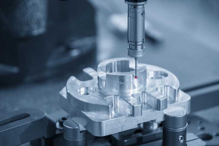 CMM machine being calibrated for manufacturing measurement.
