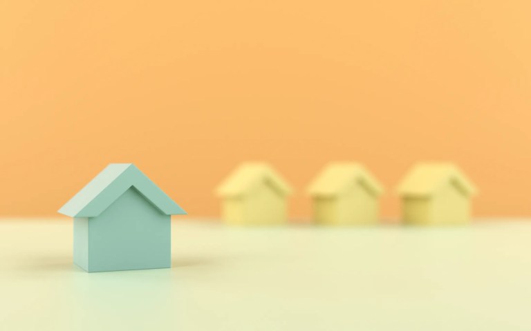 Blue wooden house before 3 yellow houses following ANSI/ASHRAE 55-2023 for thermal environmental conditions.
