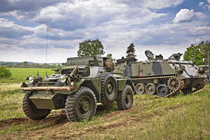 Runflat military vehicle with pneumatic tires that adhere to SAE J 2014-2022.