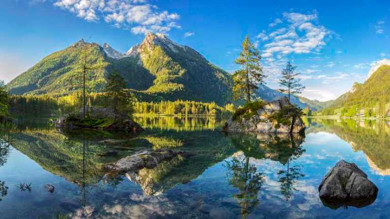 Greenery around Bavarian lake kept clean by the SEC rule on GHG disclosures for GHG verification bodies.