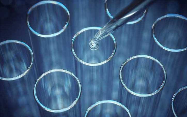 Water drop from pipette into blue test tubes.