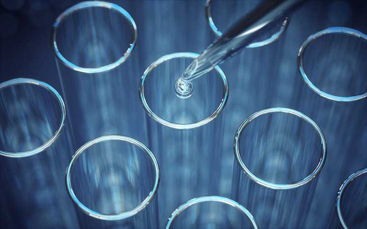 Water drop from pipette into blue test tubes.