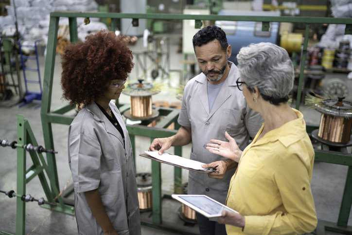 Inspector performing conformity assessment activities in a factory ensuring quality management.