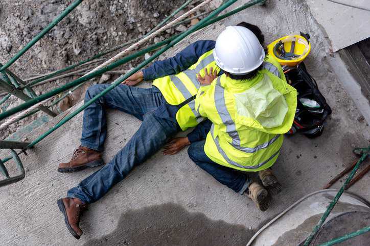 Worker falls from scaffolding on floor, violating OSHA standards.