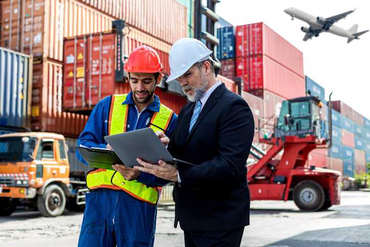 Foreman checking on shipping containers making sure they adhere to voluntary standards like American National Standards.
