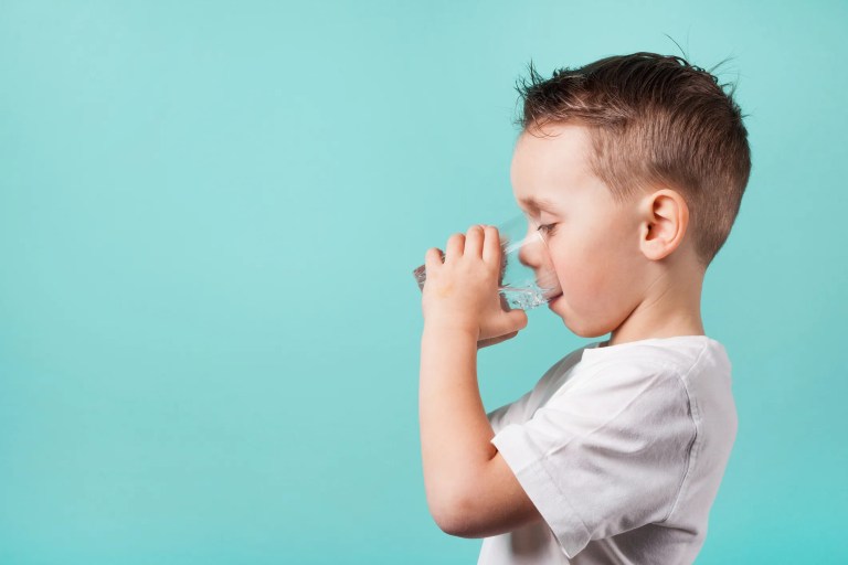 A boy hydrating with drinking water after being treated for NSF/ANSI 53-2025 health effect units.