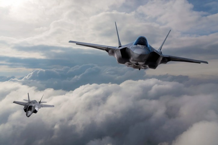 F-35 fighter jets flying over clouds