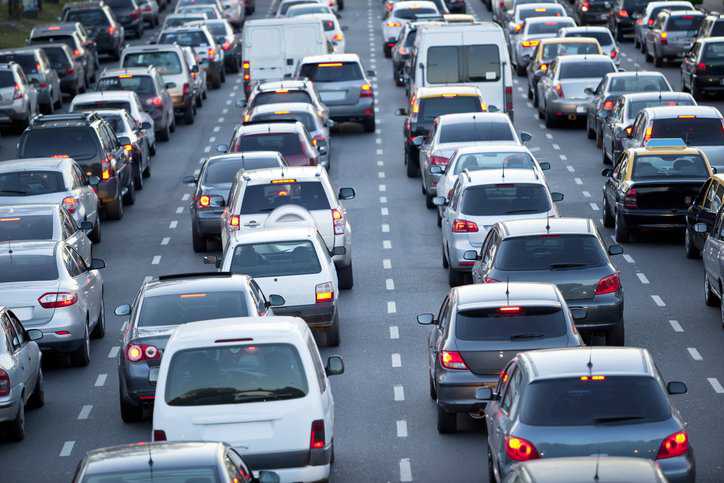 Many cars and vehicles, electric and gasoline, on a highway that adhere to ANSI/OPEI Z135-2020.