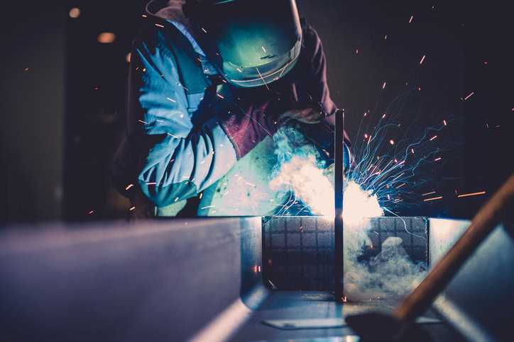 Welder preparing aerospace equipment through fusion welding specified to AWS D17.1:2024
