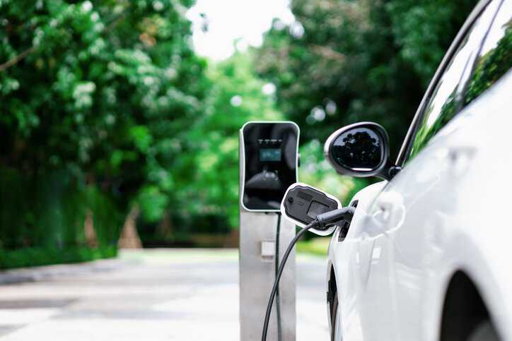 Electric vehicle (EV) plugged in with EV direct current (DC) charger device that adheres to IEC 61851-23 Ed. 2.0 B: 2023.