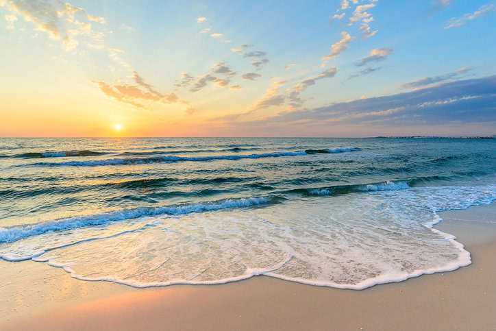 Beach wave foam rolling onto sand in Tunisian coast